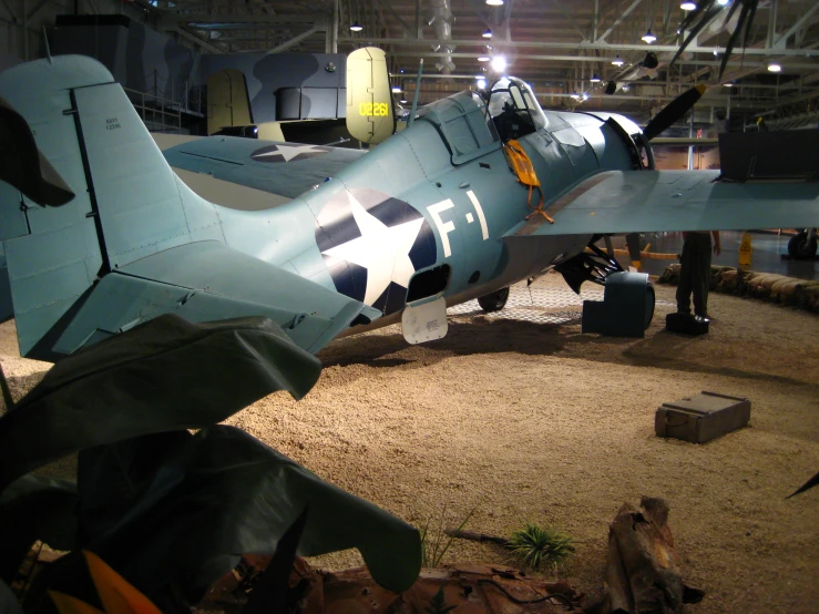 a small blue plane that is on display