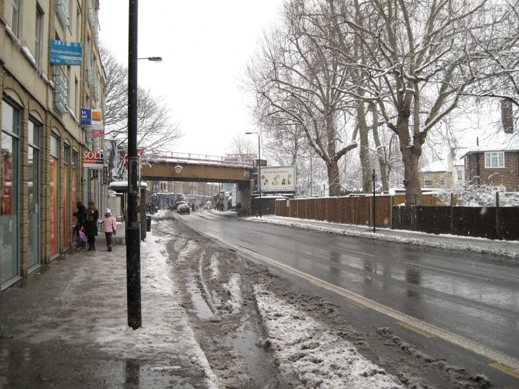 people walking down the street on a snowy day