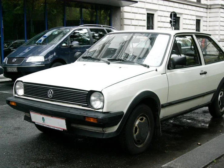 white volkswagen jett sitting parked on the side of the street