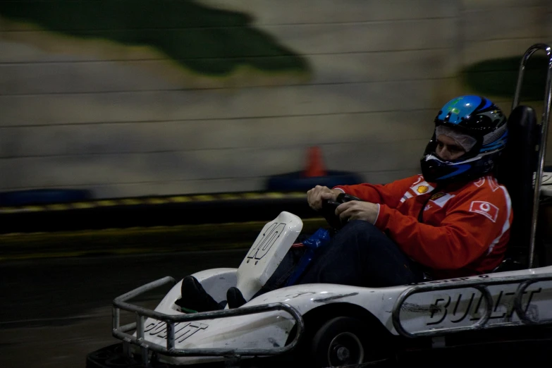 a man in a go kart racing race track