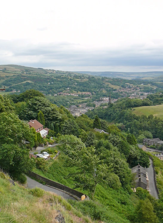 a scenic view of a hilly country setting