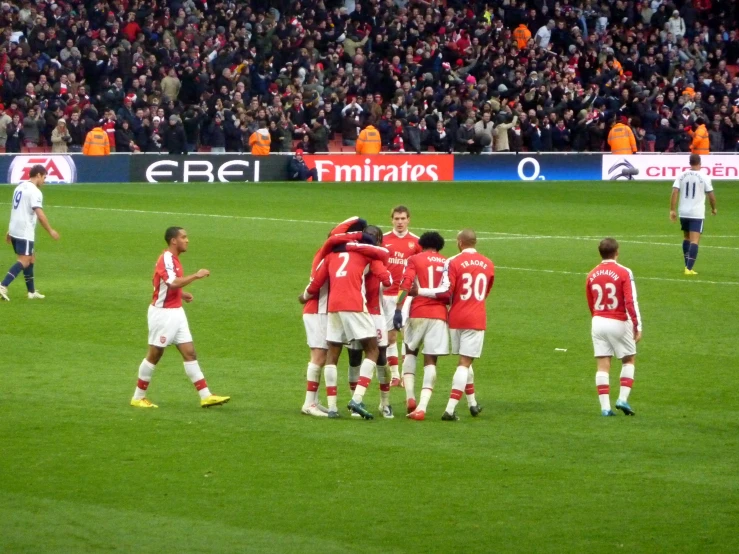 a group of men on a soccer field celeting