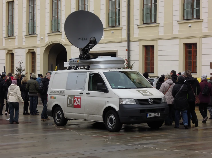 a van parked on the side of a street with people