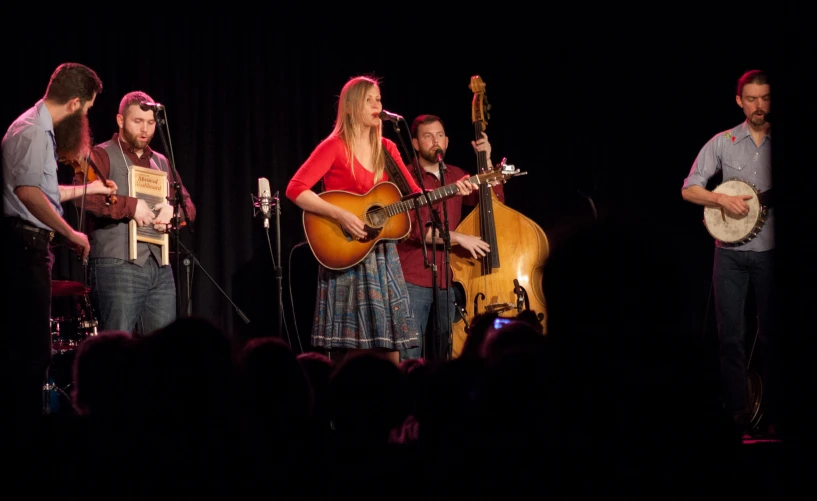 musicians performing at an event in the dark