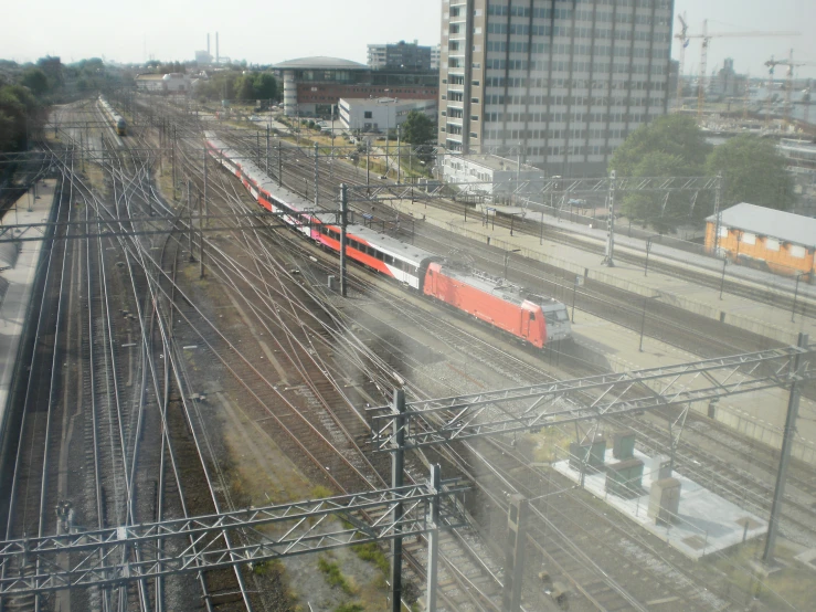 a passenger train riding down some tracks near other trains