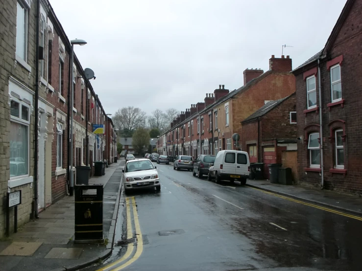 two cars are parked along the side of this street