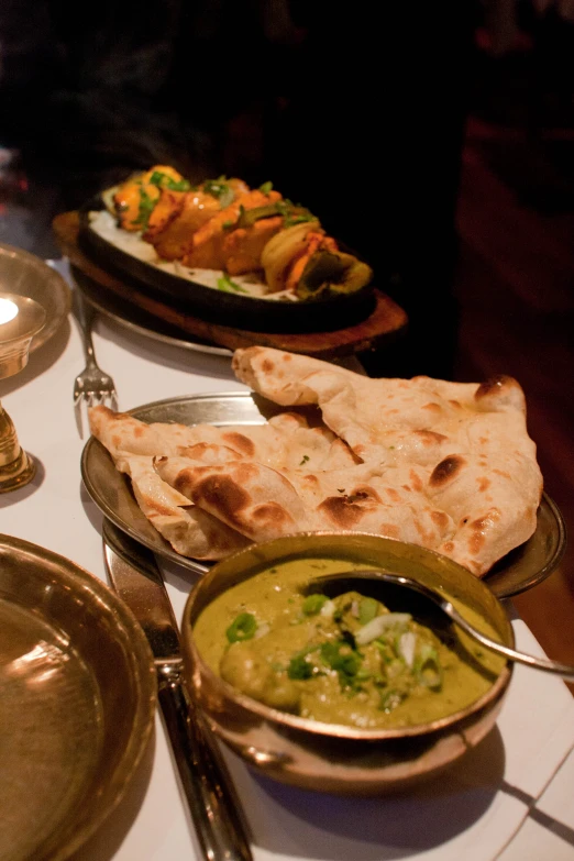 this is different dishes on a white tablecloth