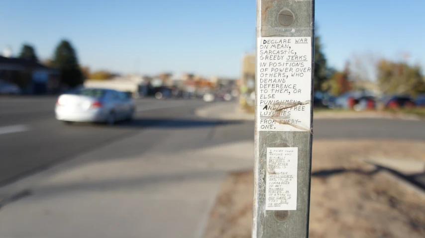 a bunch of papers on the pole by the road