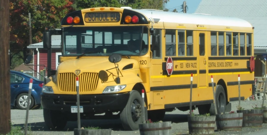 an empty school bus parked in front of the curb
