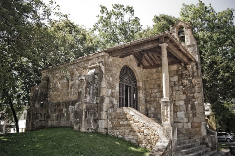 an old stone building with a staircase leading up to it