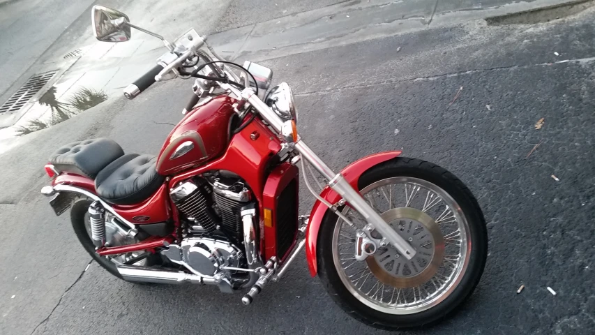 a red motorcycle parked in a parking space