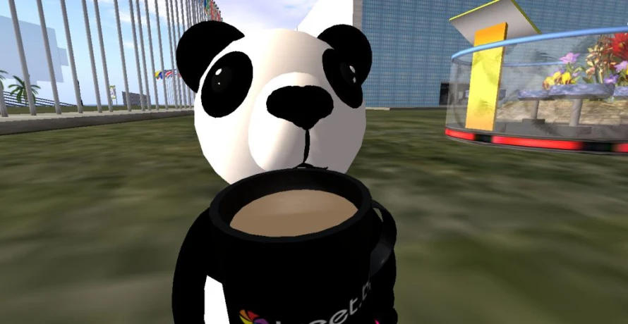 the panda is holding a coffee cup
