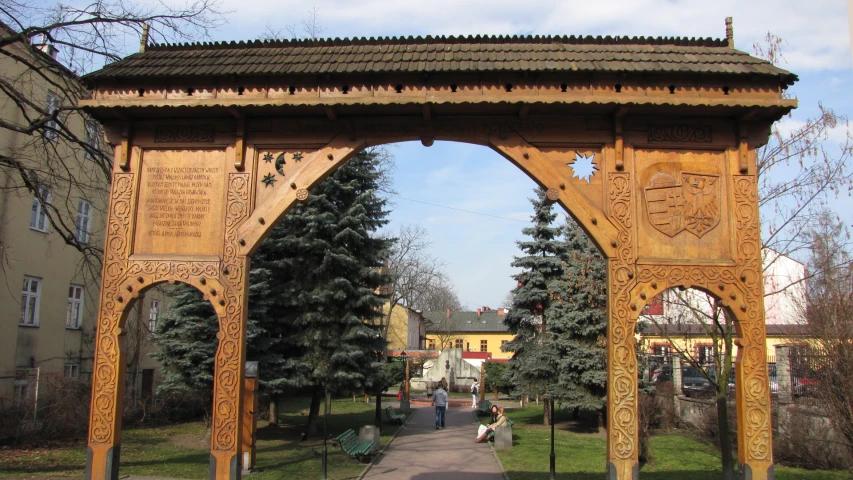 a wooden archway is an open doorway that leads into a city
