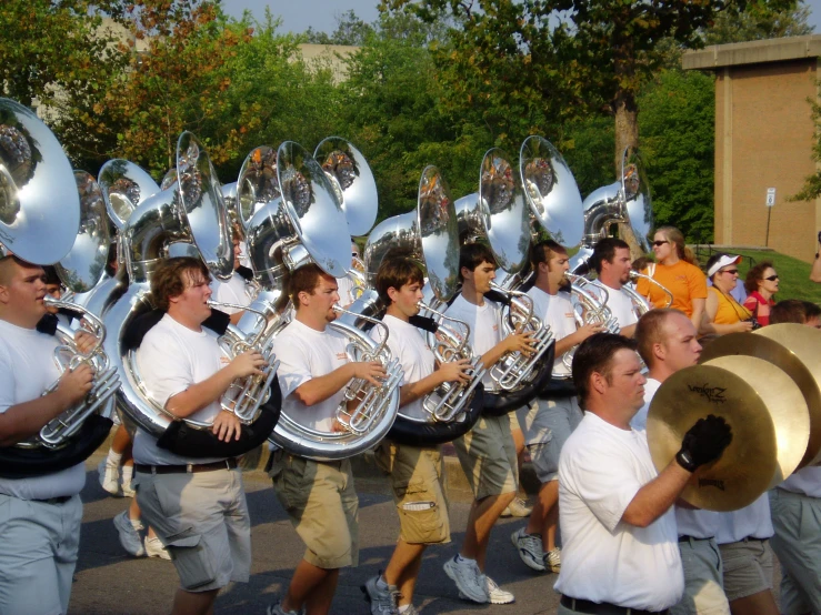 a large group of men holding marching instruments