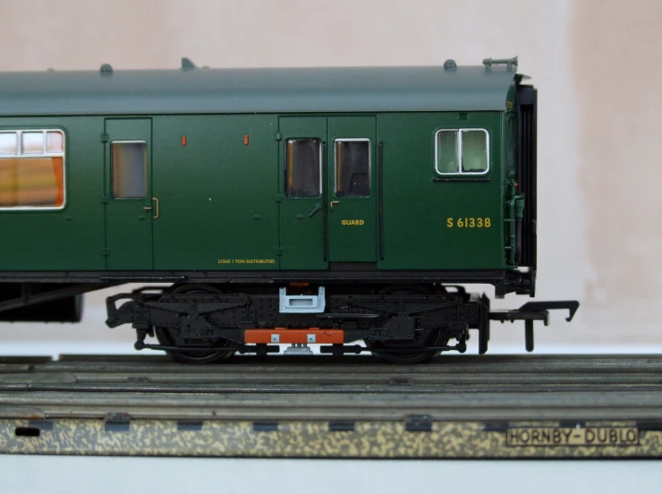 a small train car on the tracks and a model on a table