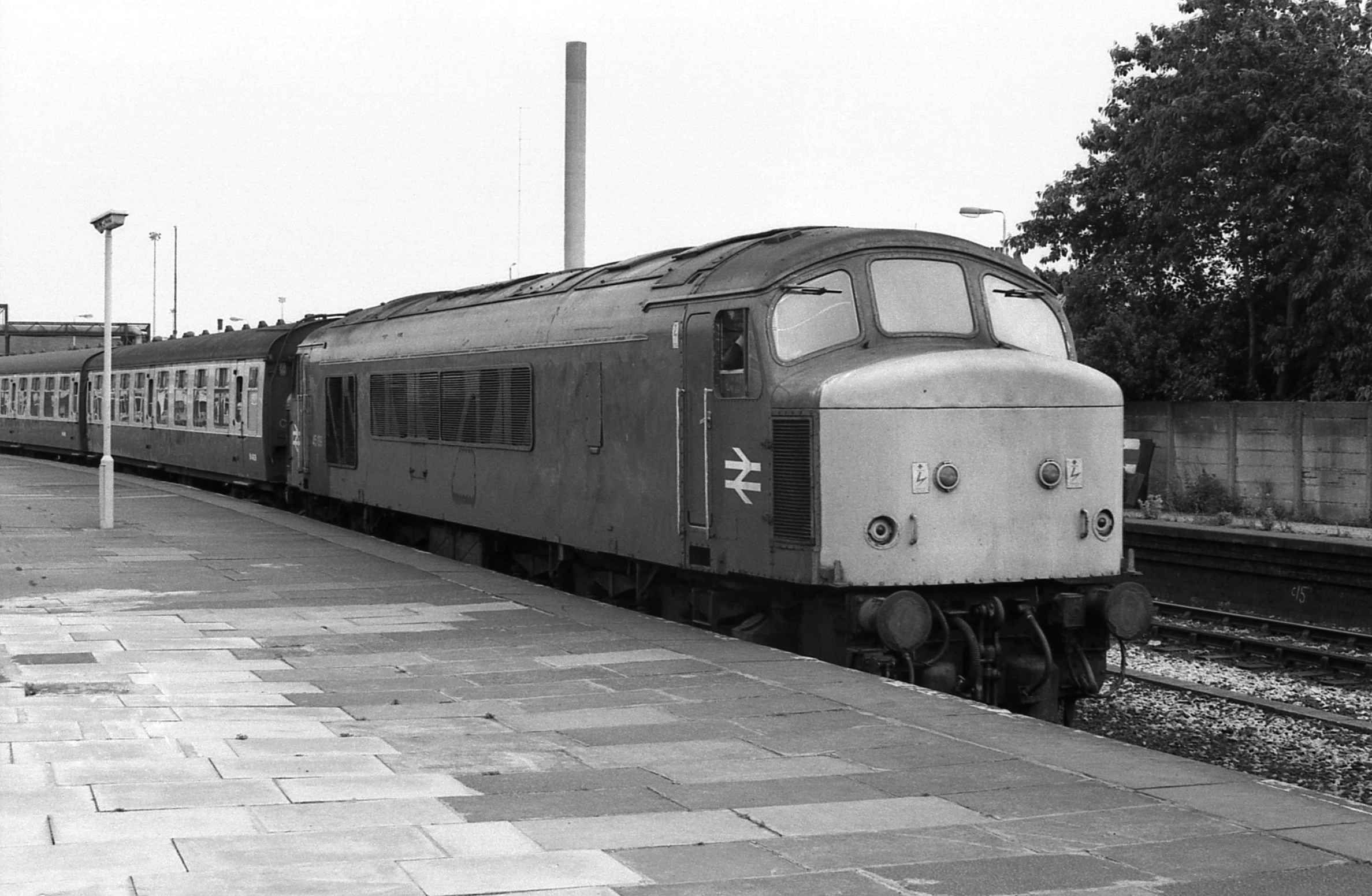 black and white pograph of a train at a station