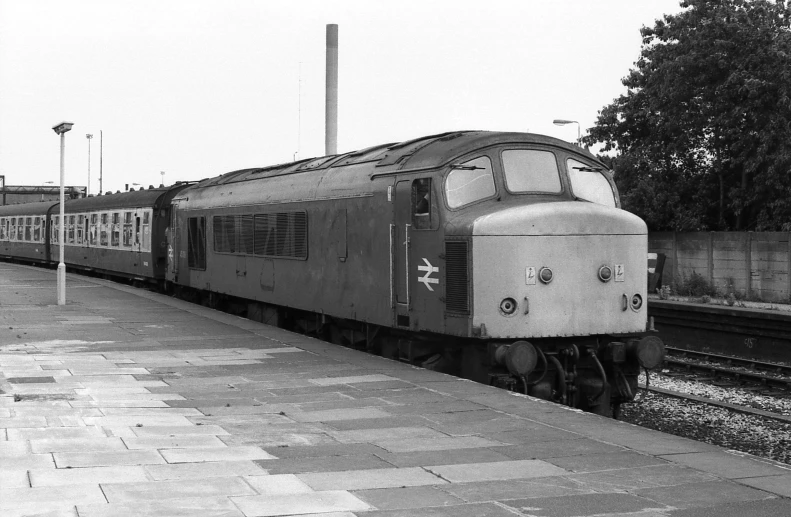 black and white pograph of a train at a station