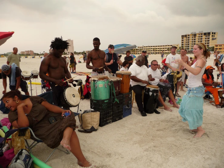 drummers with african drums play on the beach