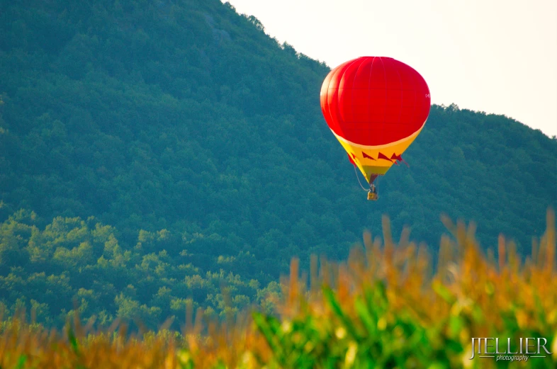 a large balloon being flown over some grass