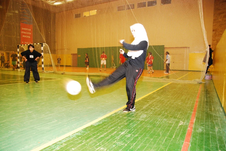 two people in white masks are kicking a ball