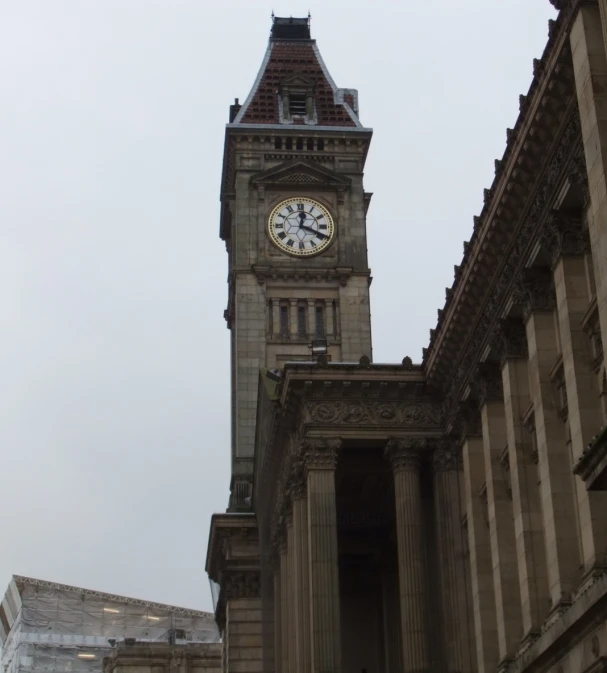 a tall stone tower with a clock at the top