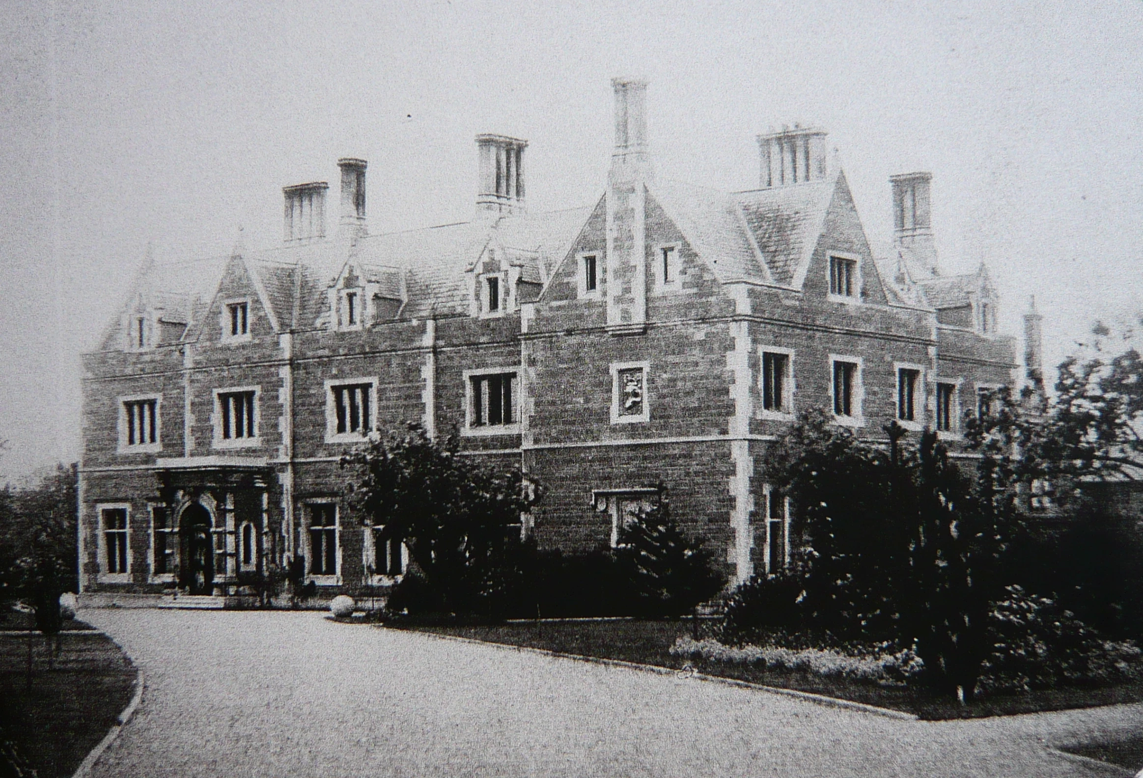 an old pograph of a large building with many windows