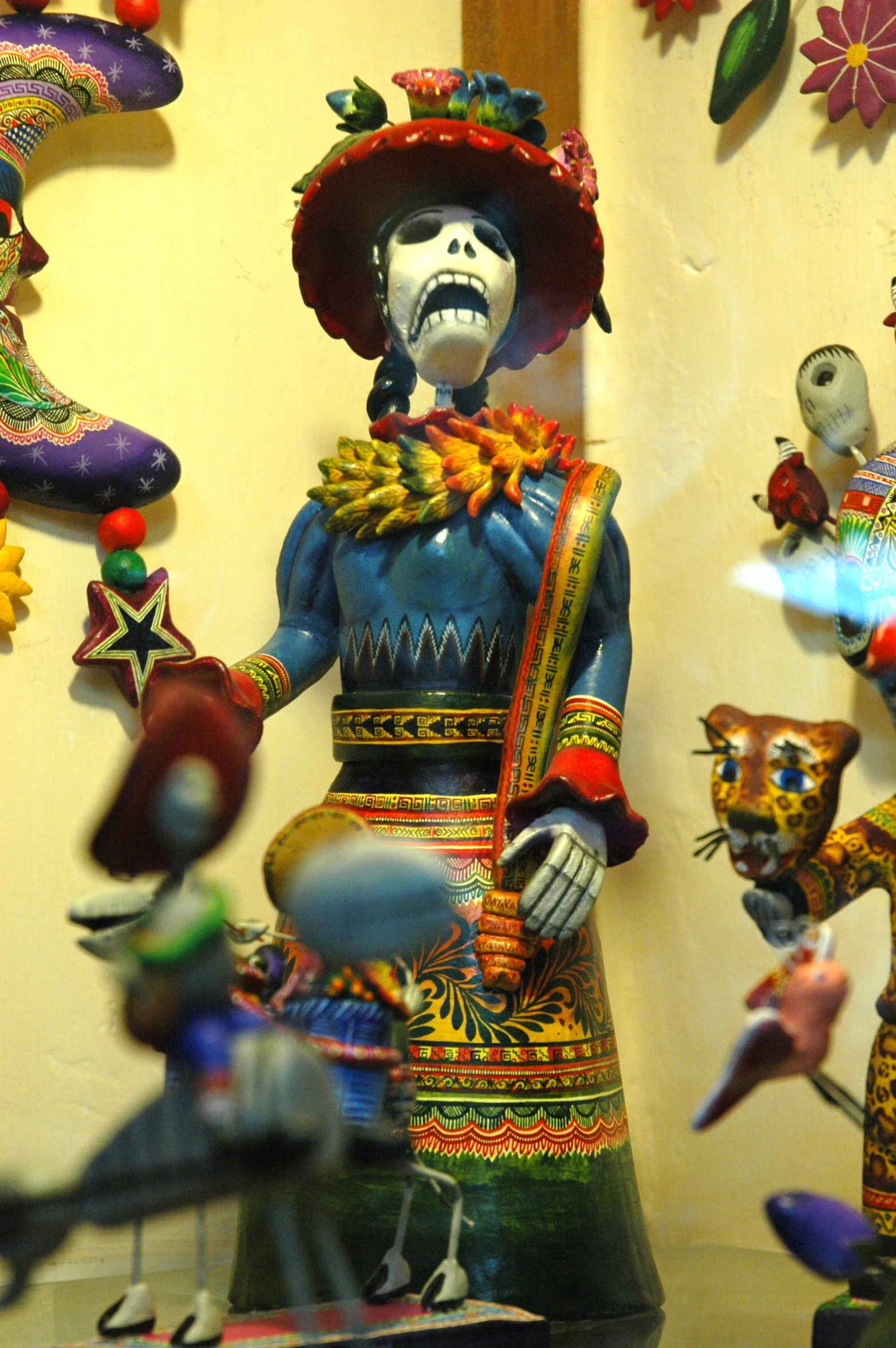 a statue of an mexican god with many other statues