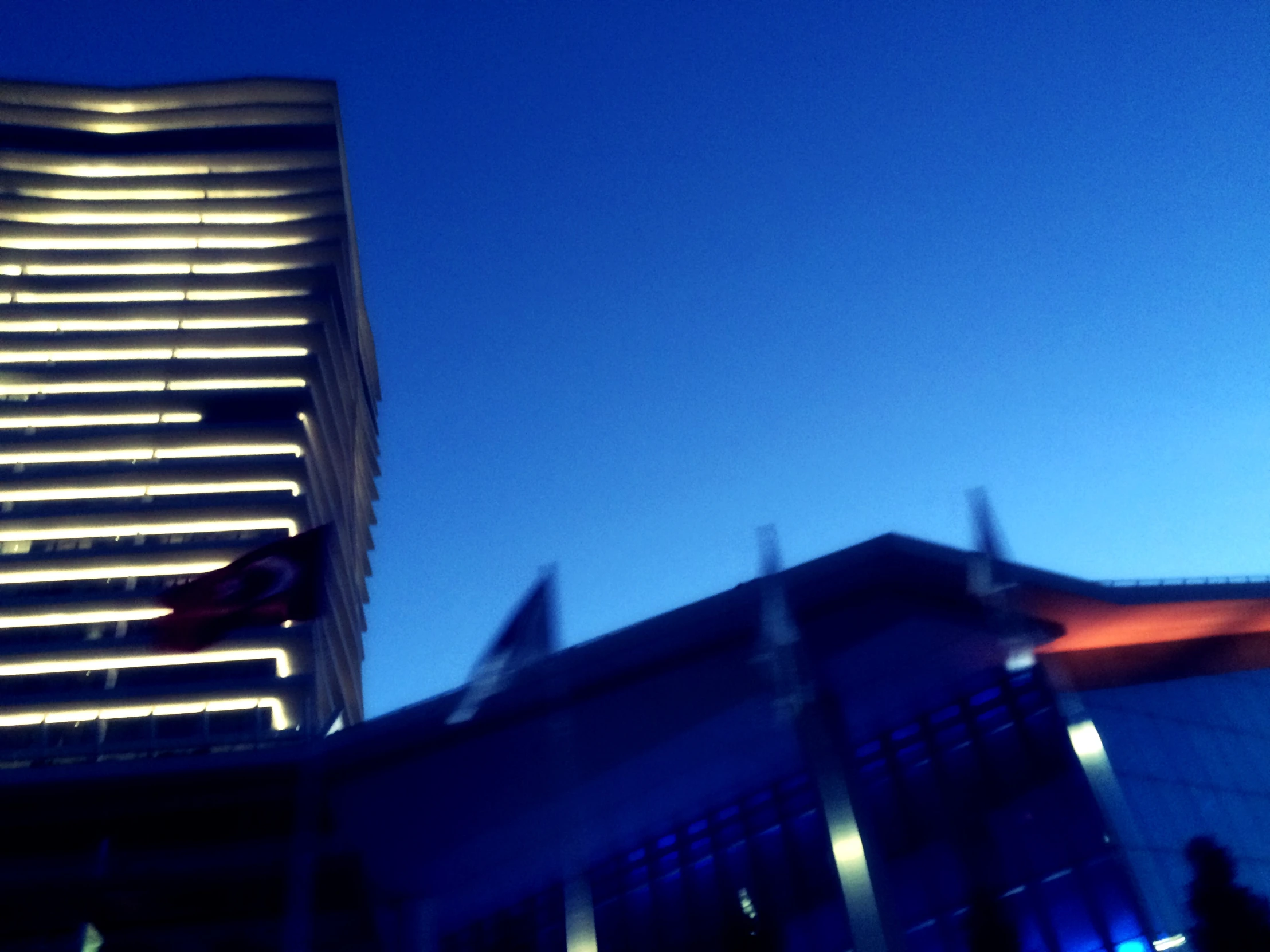 building lit up at night with blue sky