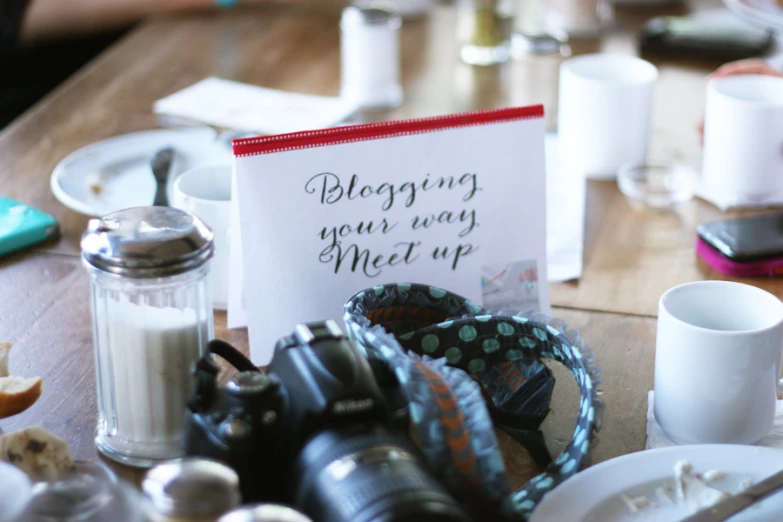 a message from a person sits on a table next to some napkins and coffee cups