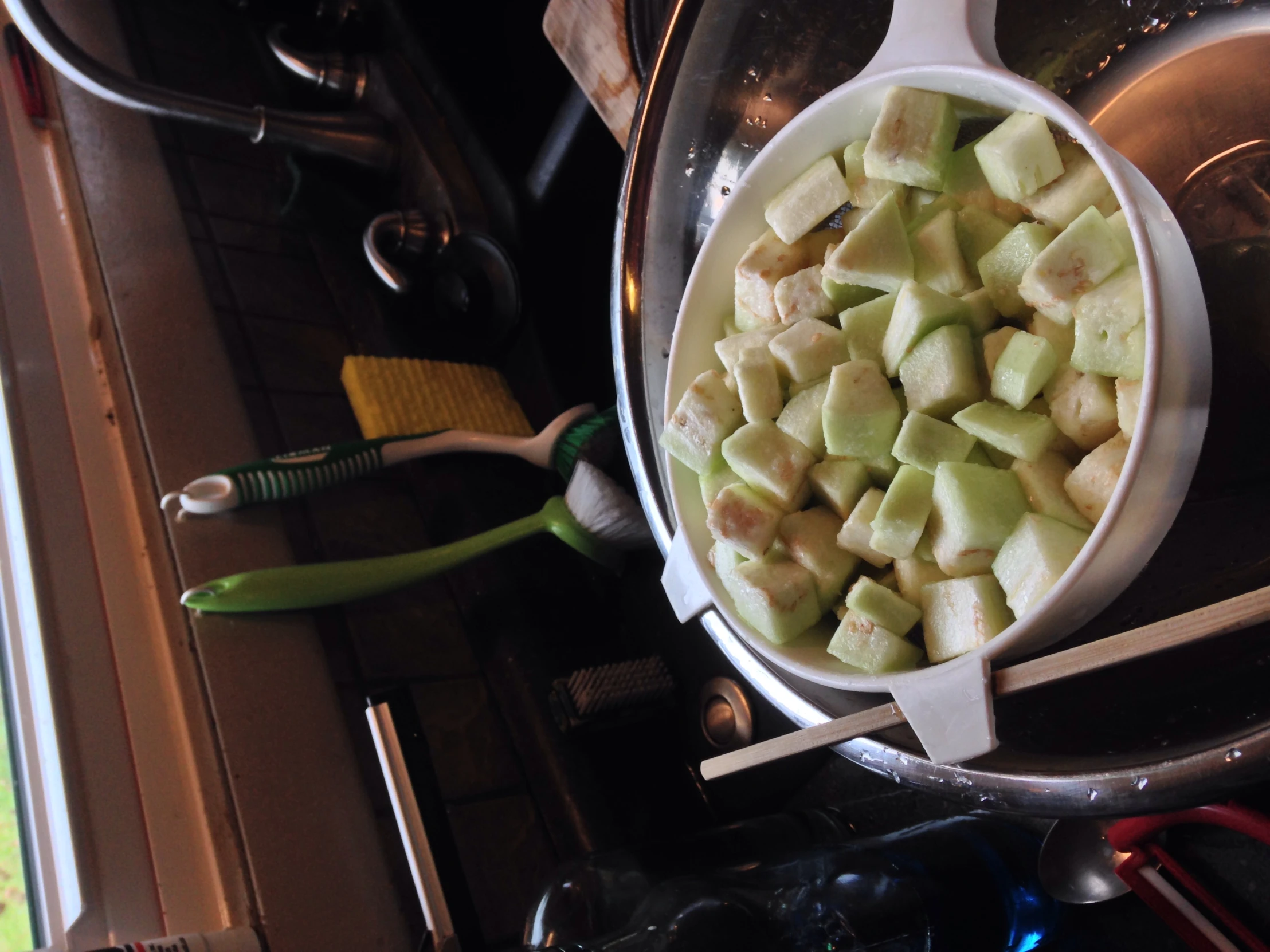 a bowl filled with chopped apples next to a spoon