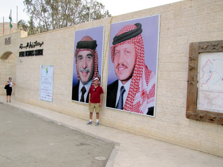 some men standing in front of two posters