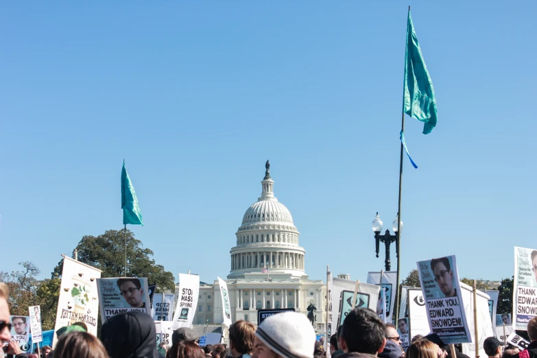 a crowd of people standing in front of the white house