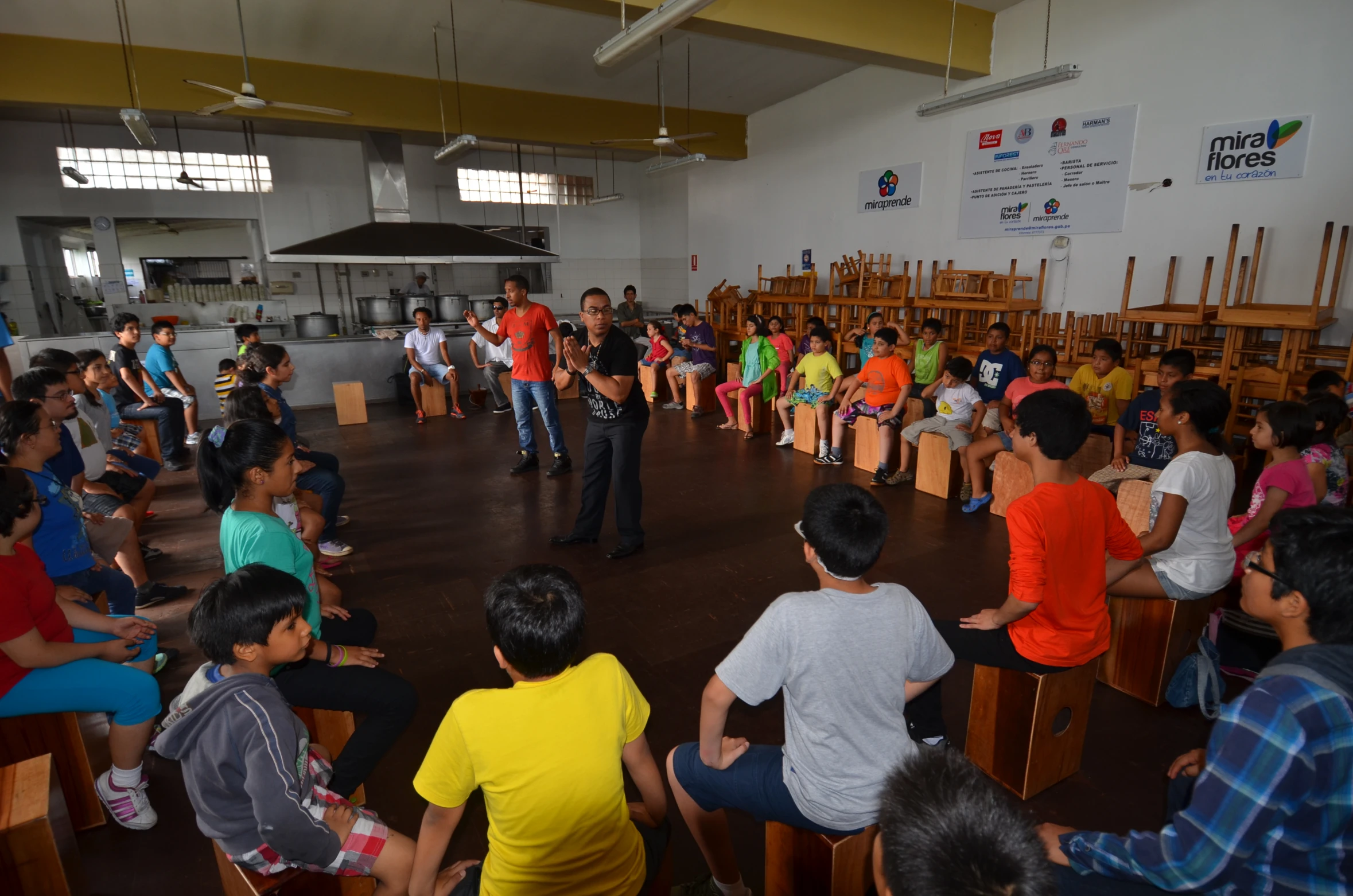 a group of people sitting in wooden chairs