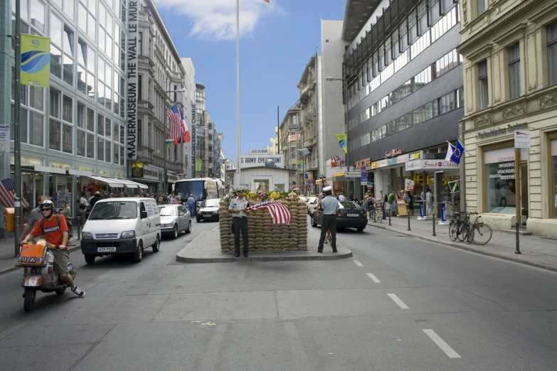 a couple of people riding scooters in a city