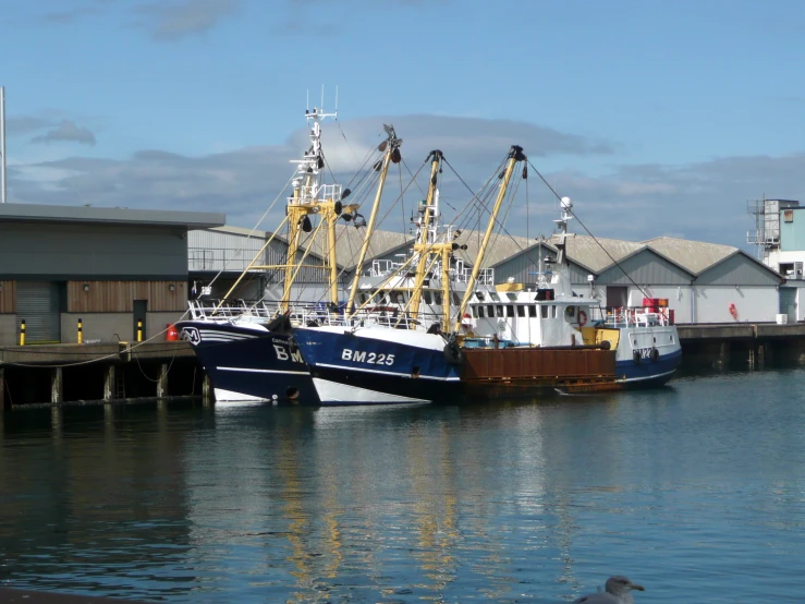 two boats parked in the dock of a harbor