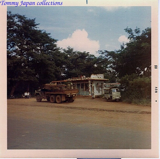 an old po with some trucks in front of trees