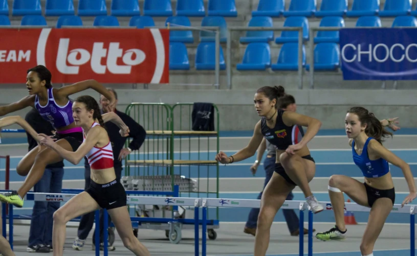 a female runner is running behind a fence