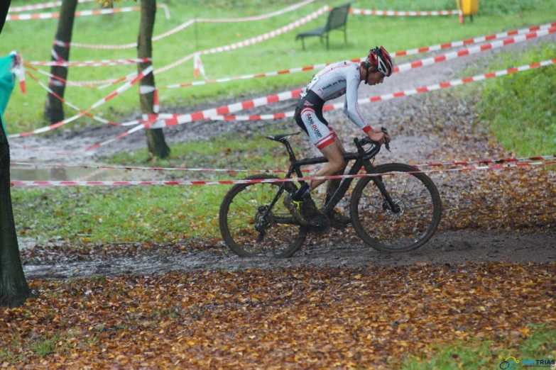 the person is riding their bike around a race course