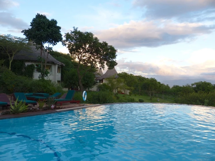 a pool with chairs in the middle near it