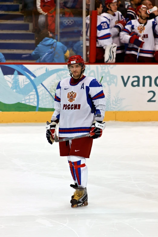 a man is wearing protective clothing on a ice rink