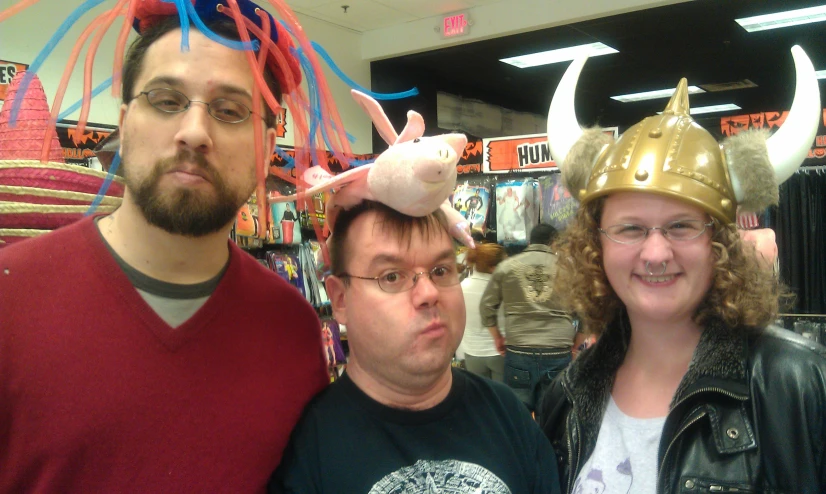 two men and a woman with fake horns on their head