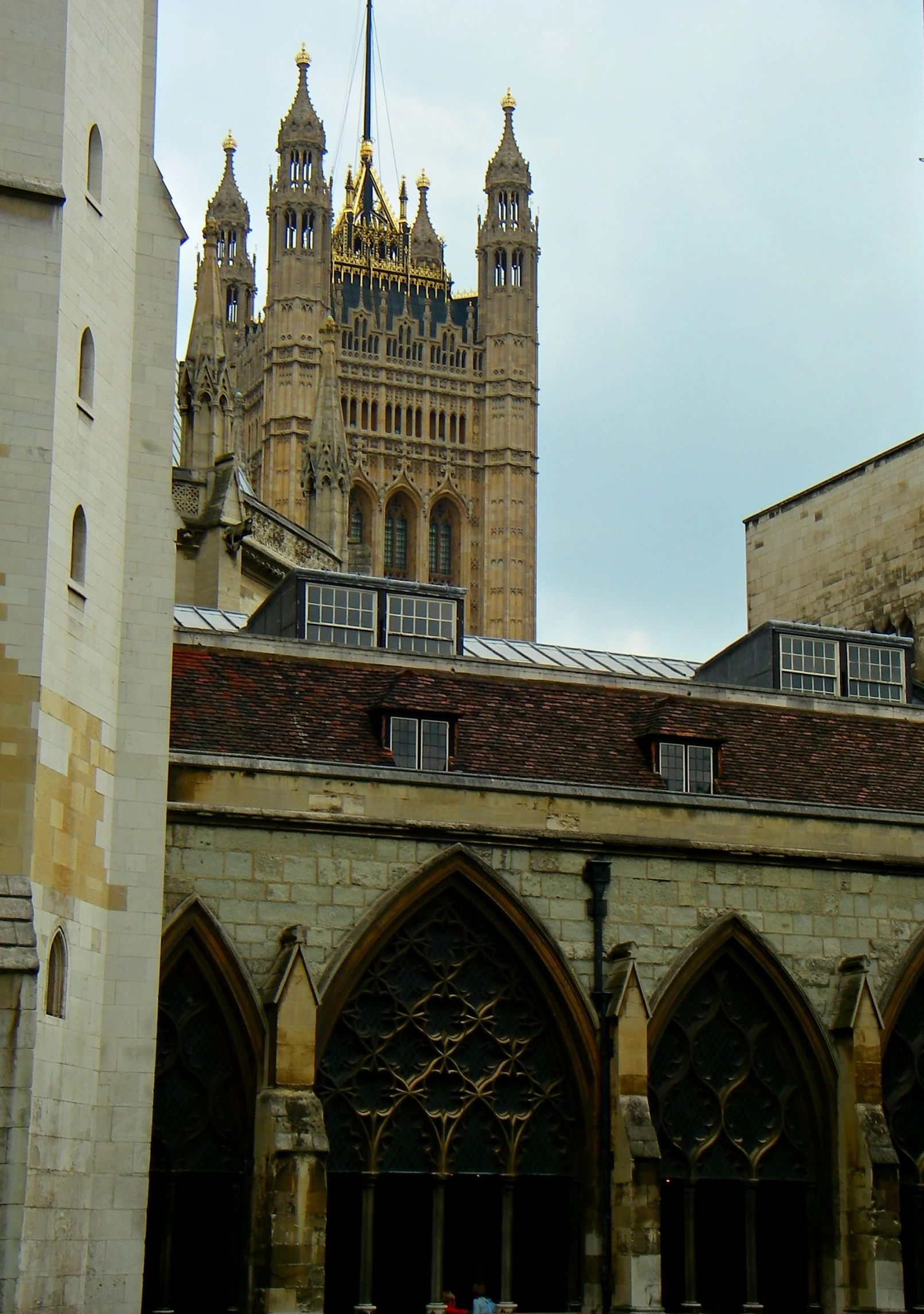 a clock on the tower of a building near other buildings