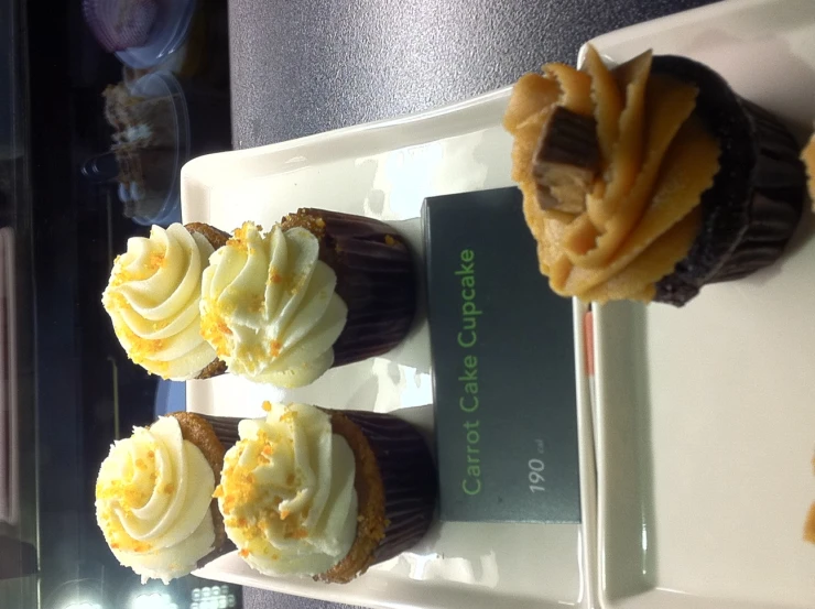 three different cupcakes are on display on a plate