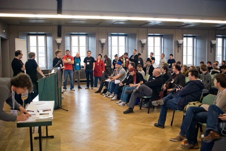 group of people listening to a public presentation