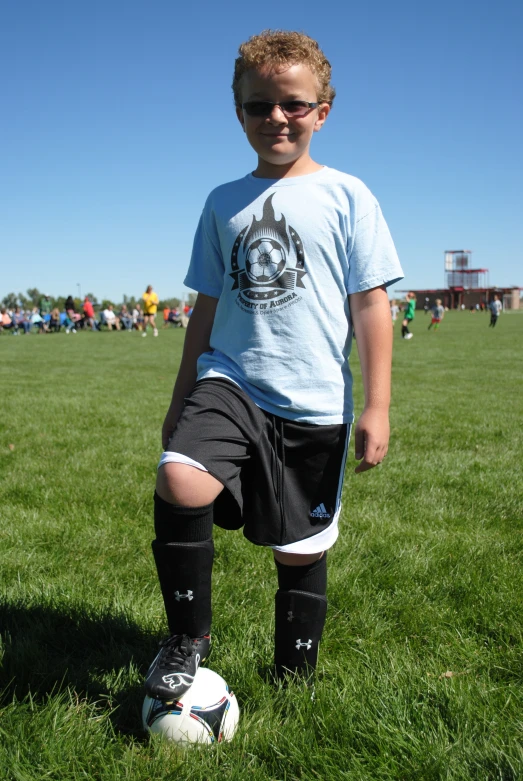 a boy in a soccer field posing for a po