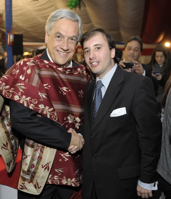 two men in business suits are holding each other