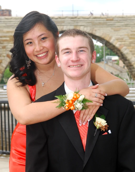 a young man and woman in formal wear emcing each other