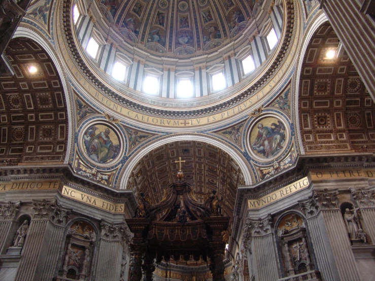 a domed church with high ceilings, painted gold and white