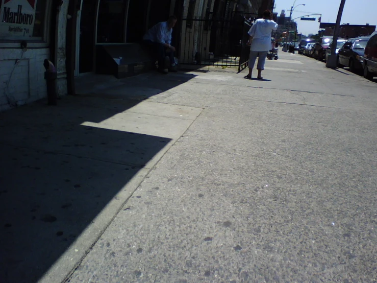 a person walking down a sidewalk near a bus