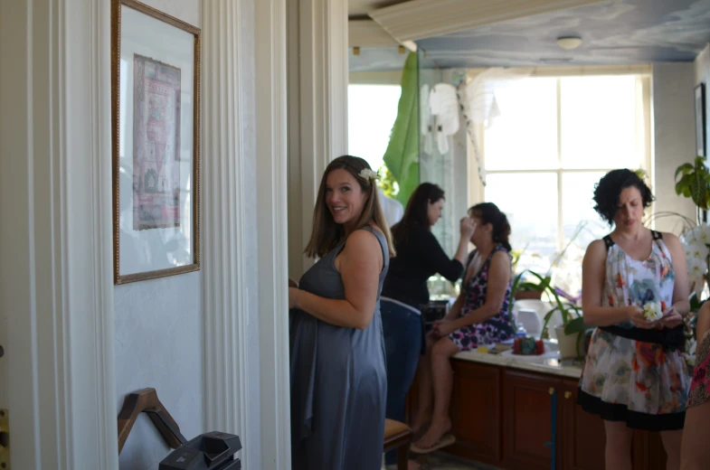 several women are all in the kitchen talking to each other